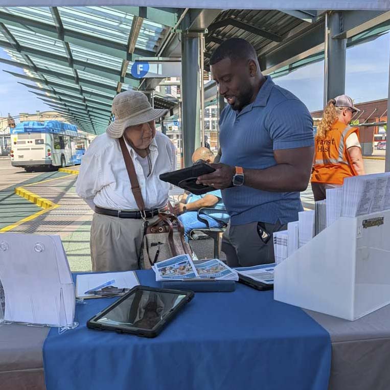 Microtransit Outreach - outreach representative talks to a rider