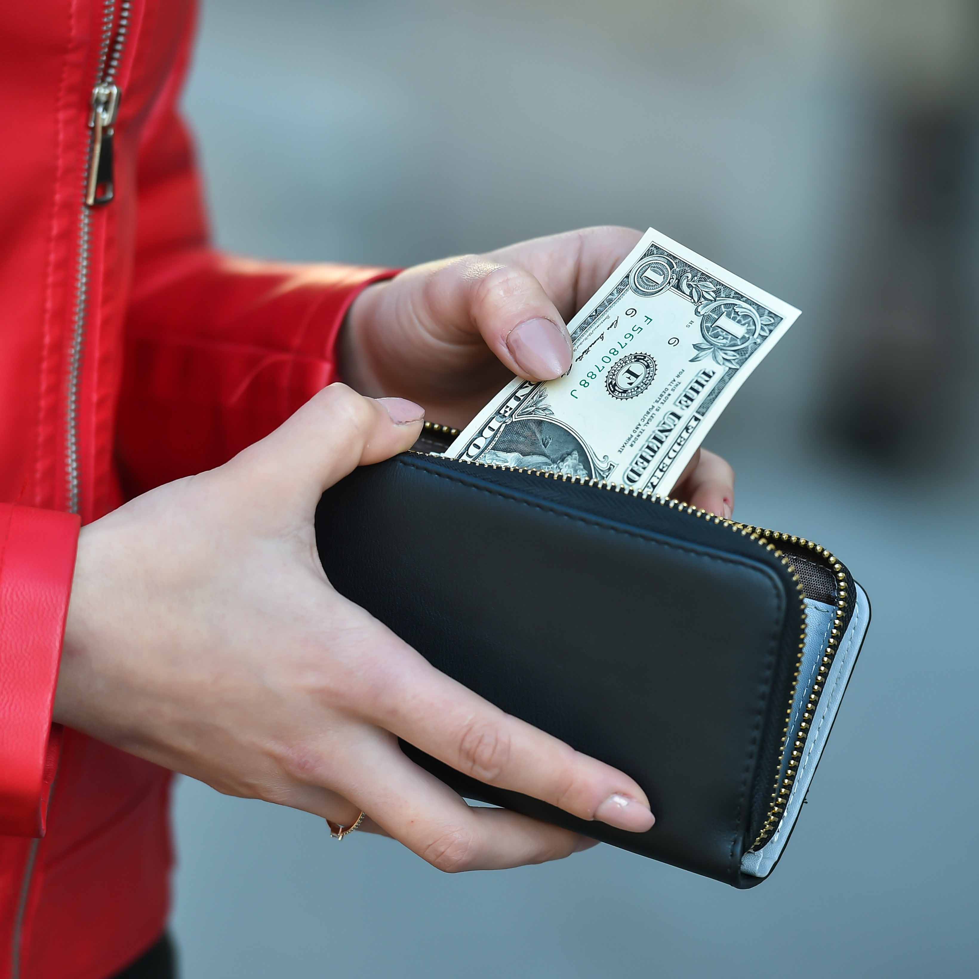 Woman pulling money out of a wallet